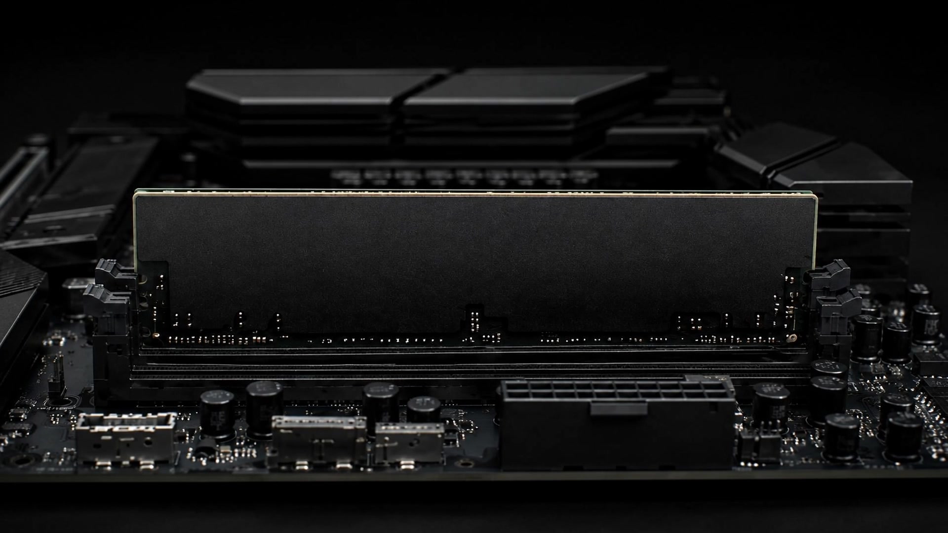A RAM module installed on a dark motherboard